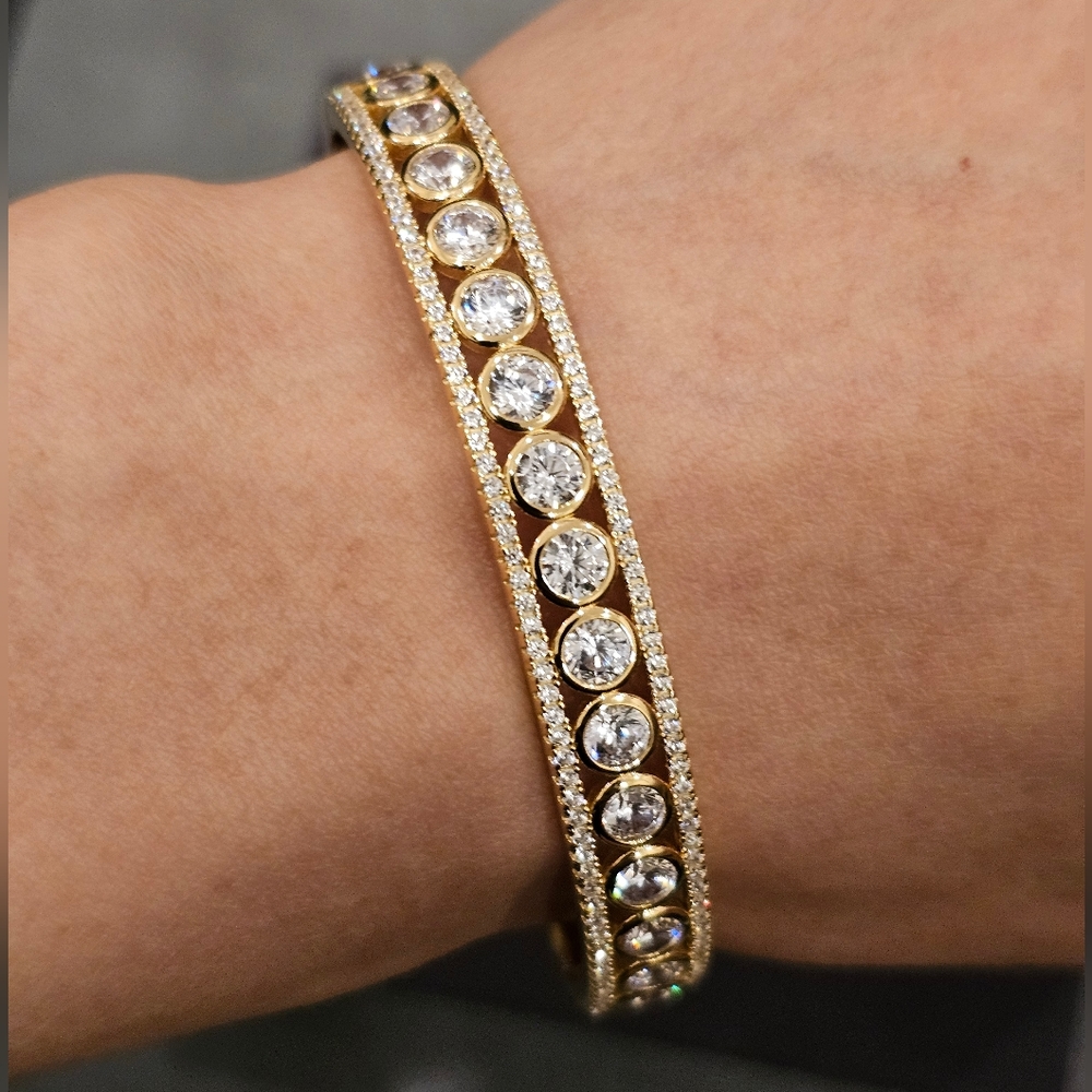 Cubic Zirconia set in 14k gold plated sterling silver bangle. 7" circumference.